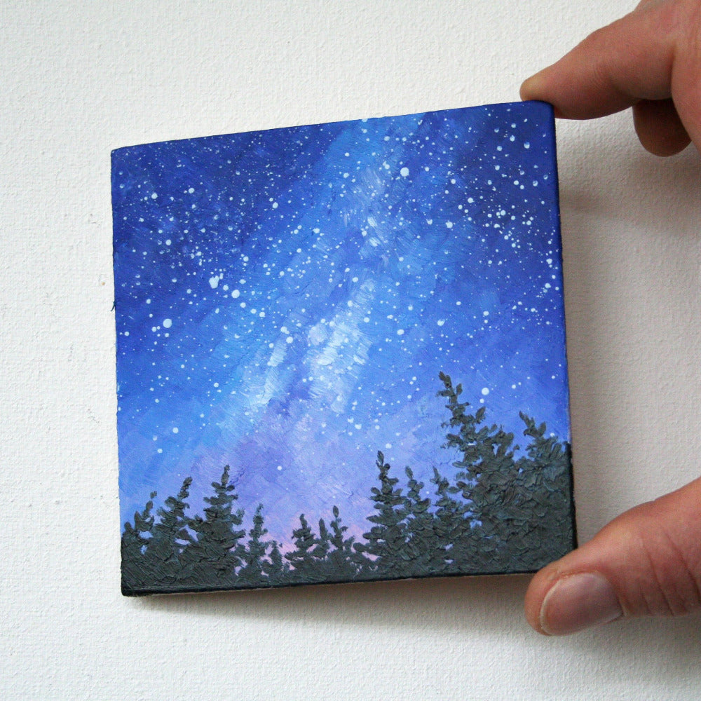 Hand-painted night sky landscape with glowing Milky Way stars and subtle pine silhouettes.