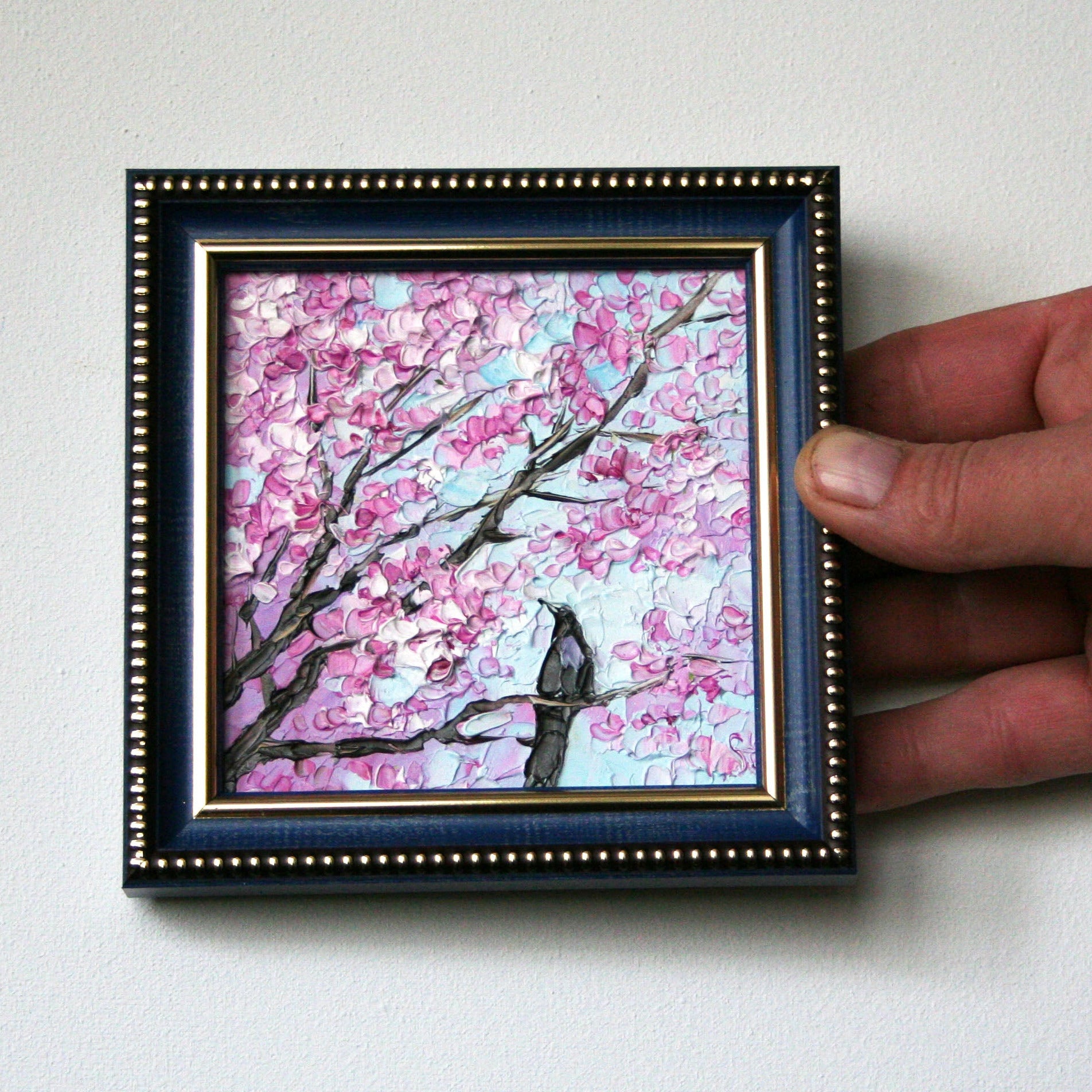 Mini oil painting of cherry blossoms and a bird in a frame by Iryna Stakhiv