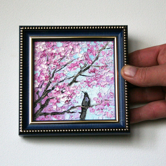 Mini oil painting of cherry blossoms and a bird in a frame by Iryna Stakhiv