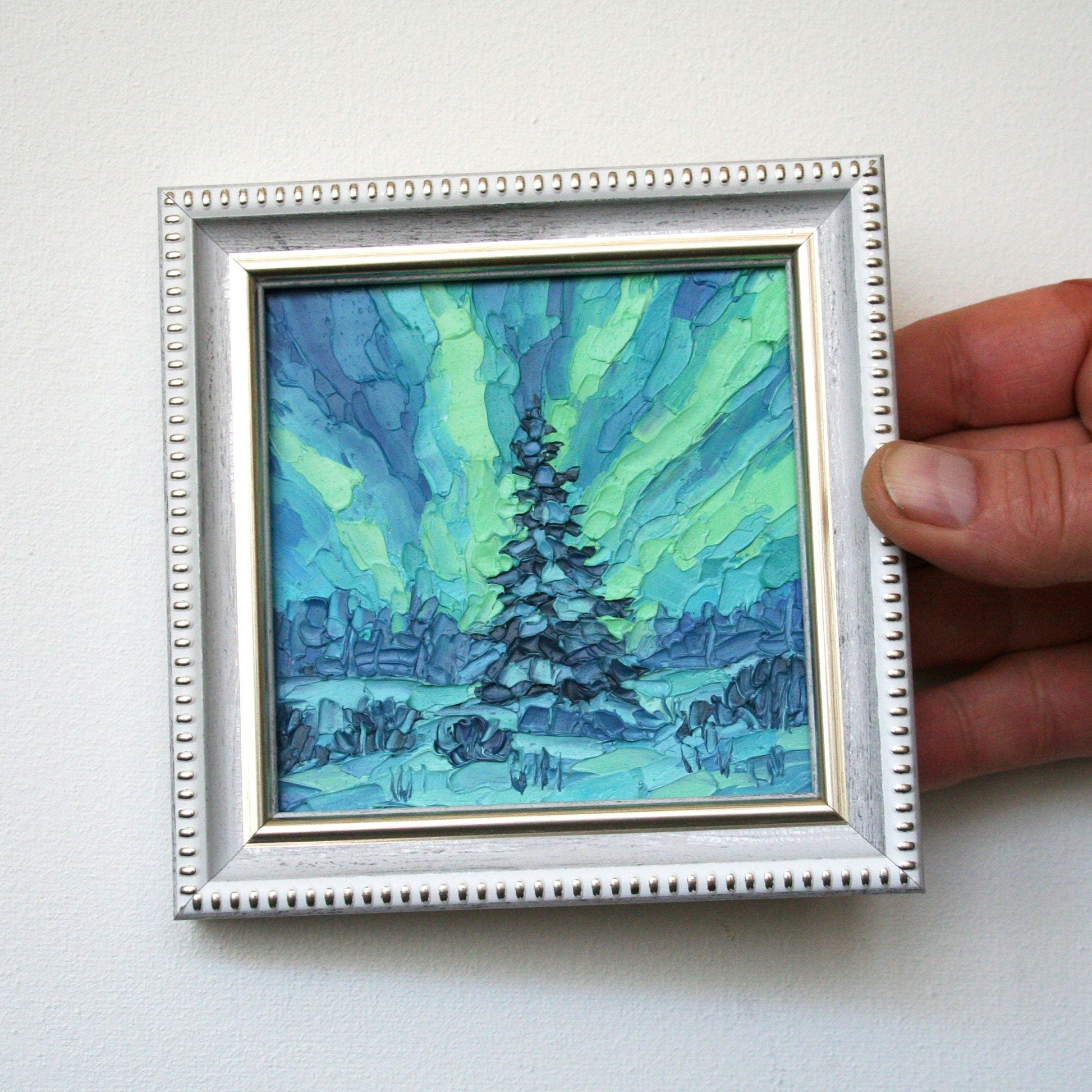 Close-up of impasto texture on Northern Lights mini painting, bold palette knife night sky strokes