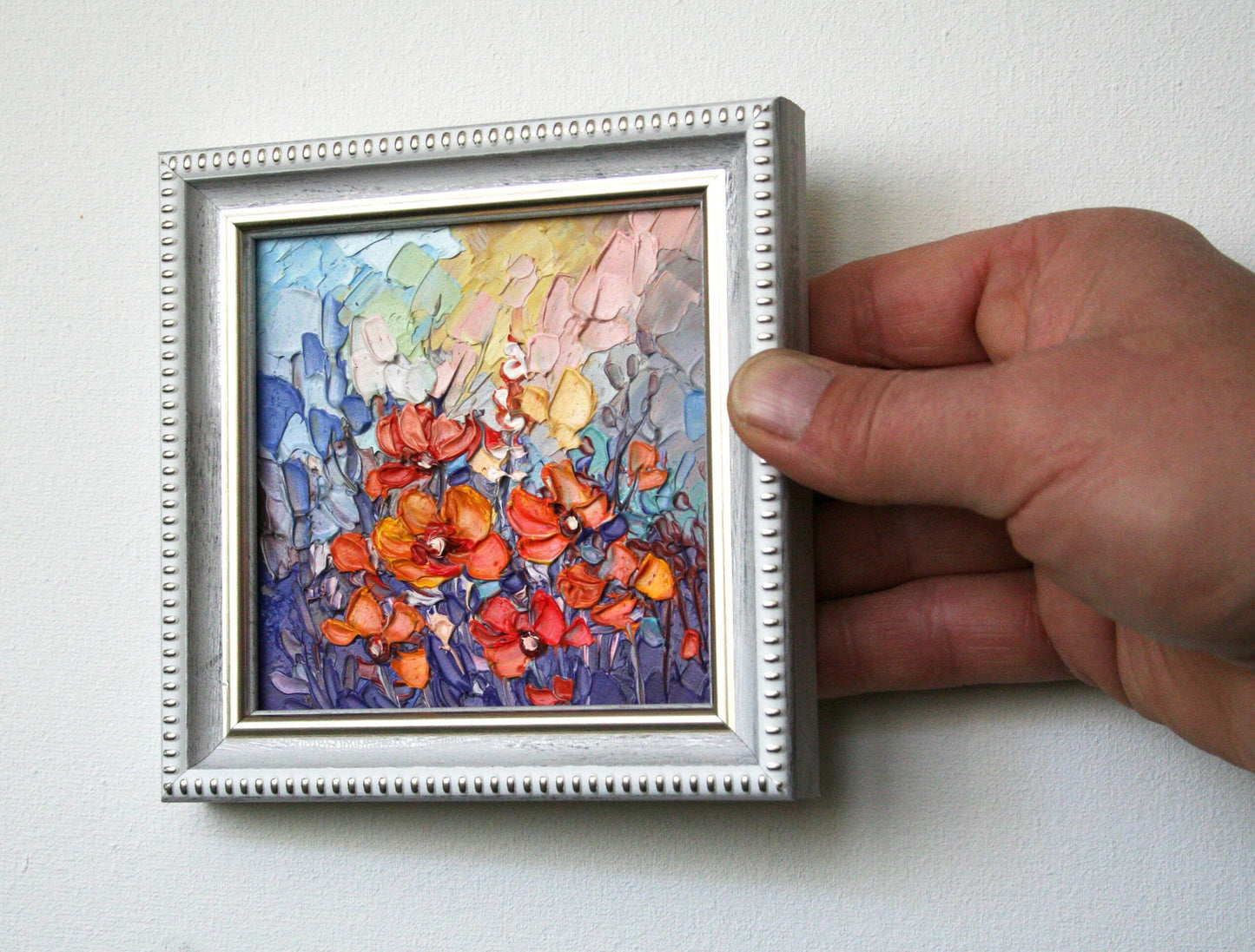 Close-up of impasto texture on abstract floral painting, bold palette knife strokes