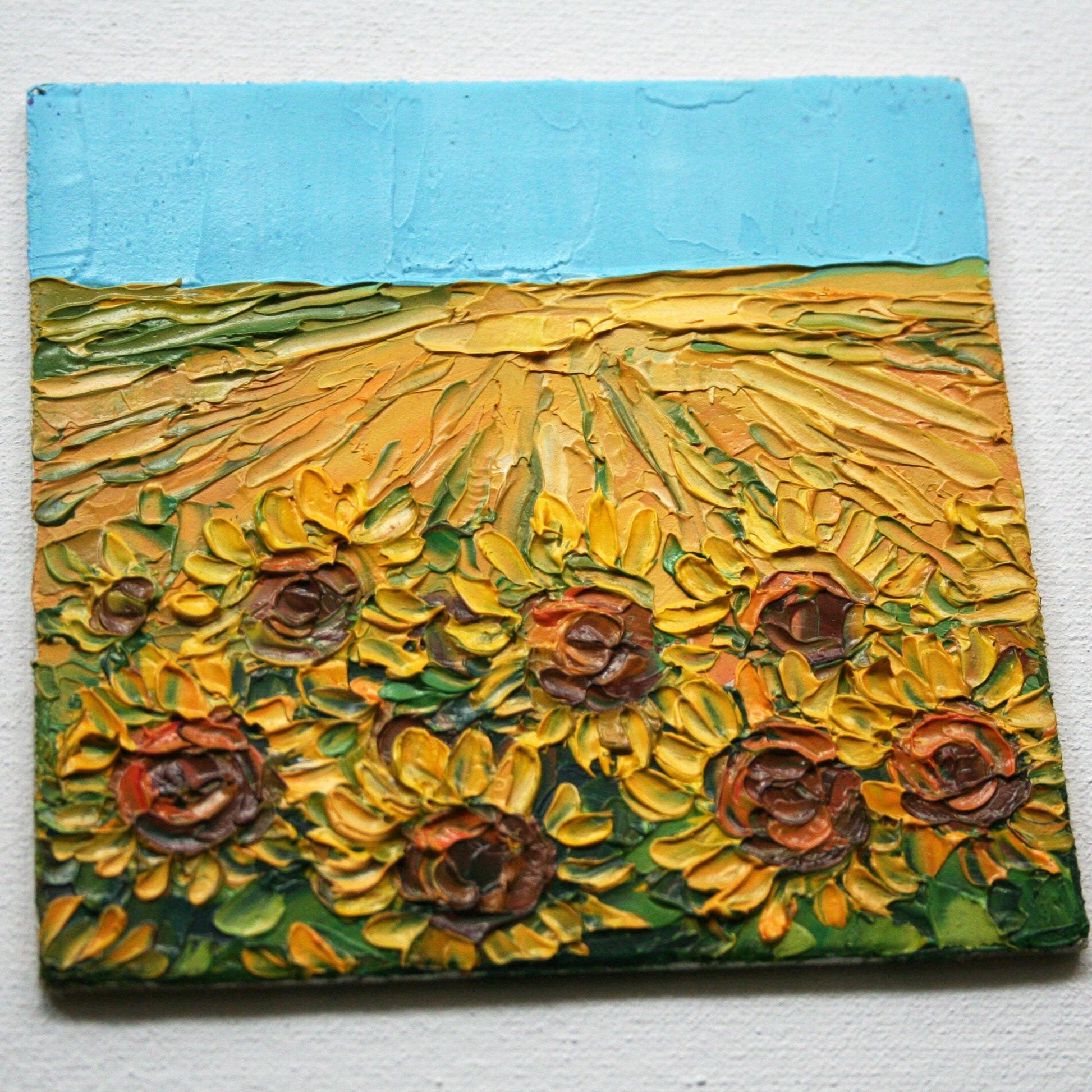 Close-up of impasto texture on sunflower mini painting, bold palette knife strokes