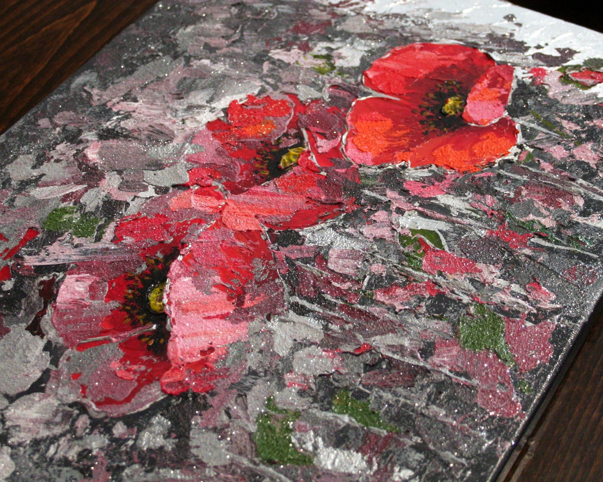 Close-up of textured red poppies painting, acrylic with silver leaf and glitter detail