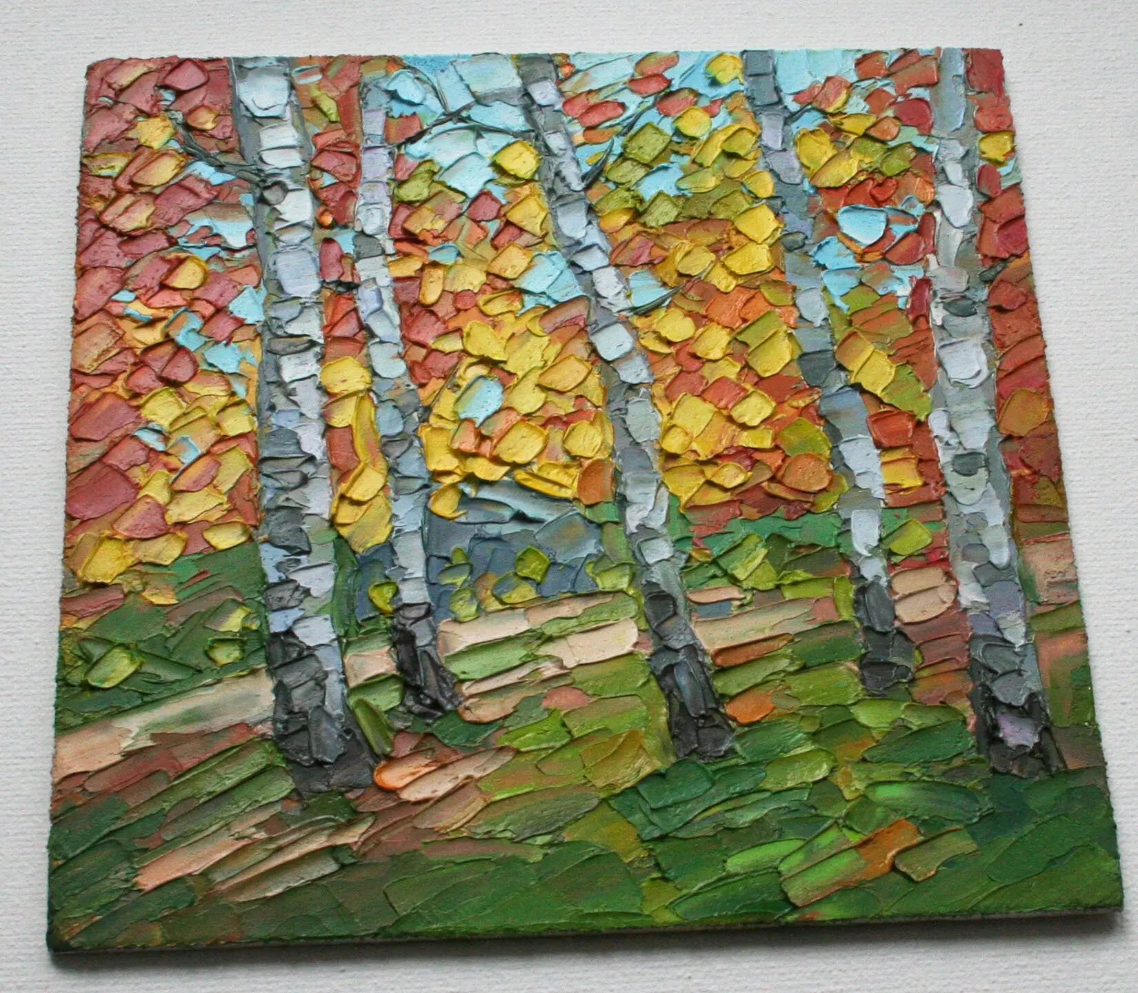 Close-up texture of impasto palette knife painting — birch forest fall foliage, thick oil paint
