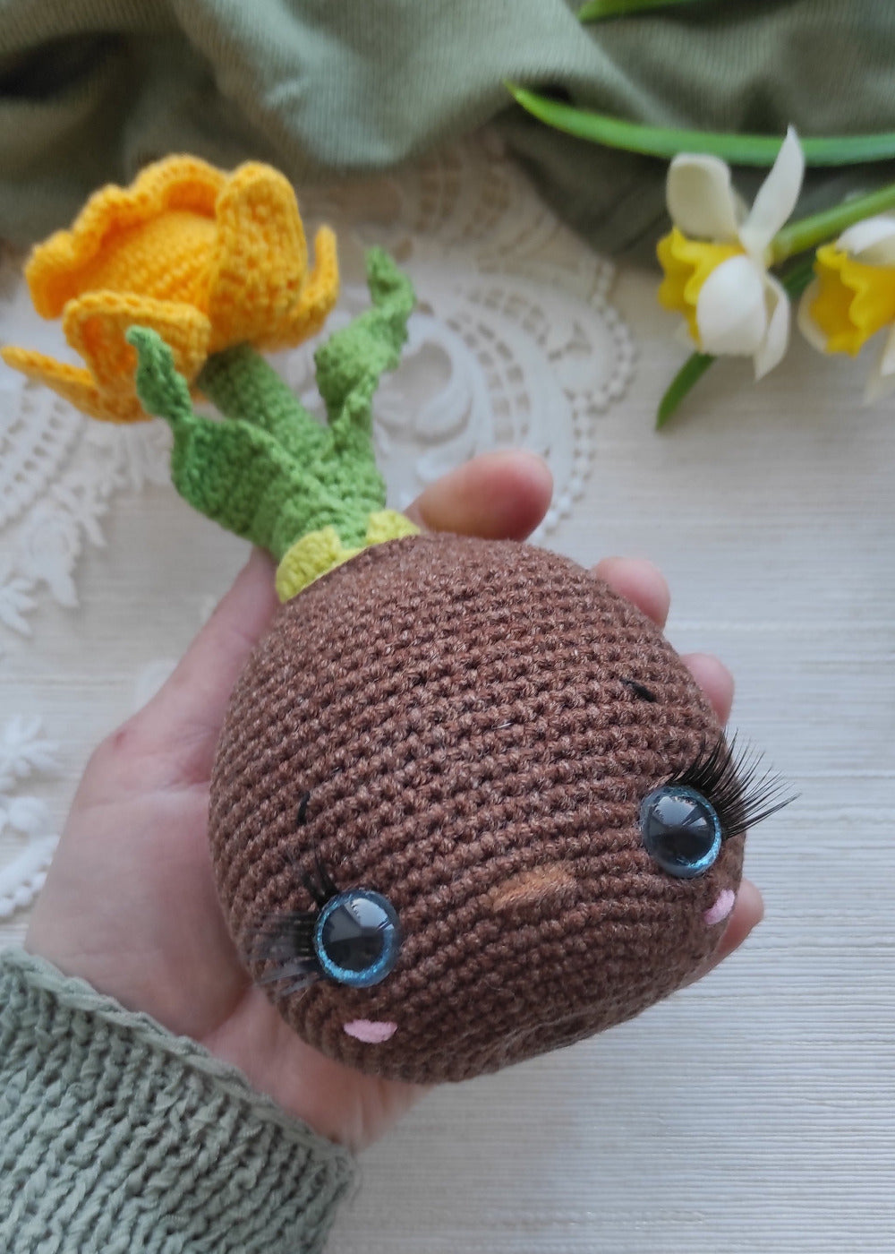 Crochet pot with safety eyes and glued eyelashes, handmade amigurumi detail