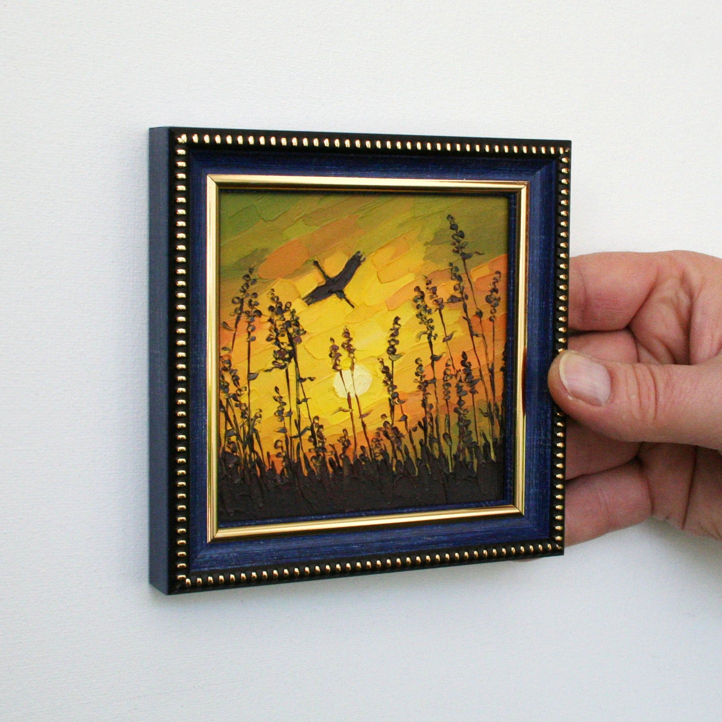 Framed mini oil painting with warm orange sunset and bird silhouette, impasto art