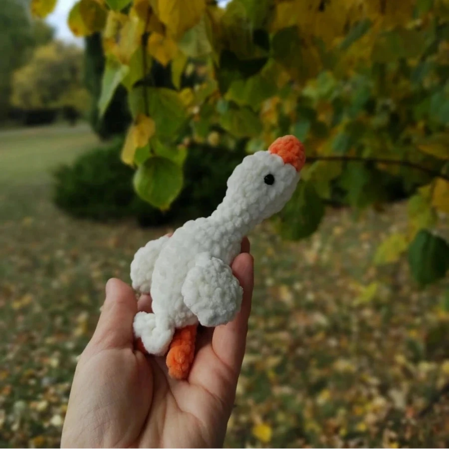 Handmade crochet goose 14cm in hand, white plush yarn, orange beak and feet, bead eyes — stuffed animal toy