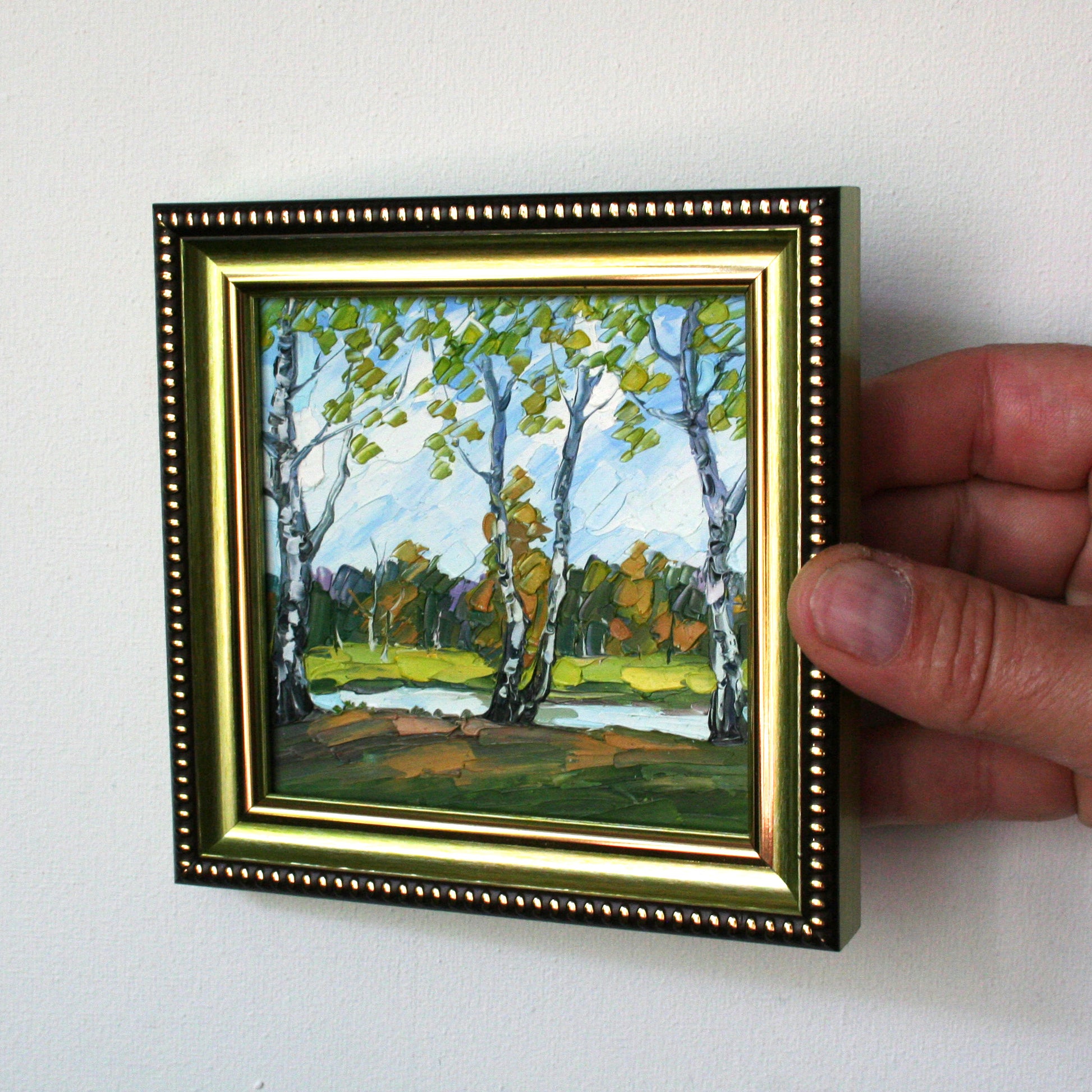 Small framed oil painting of birch trees