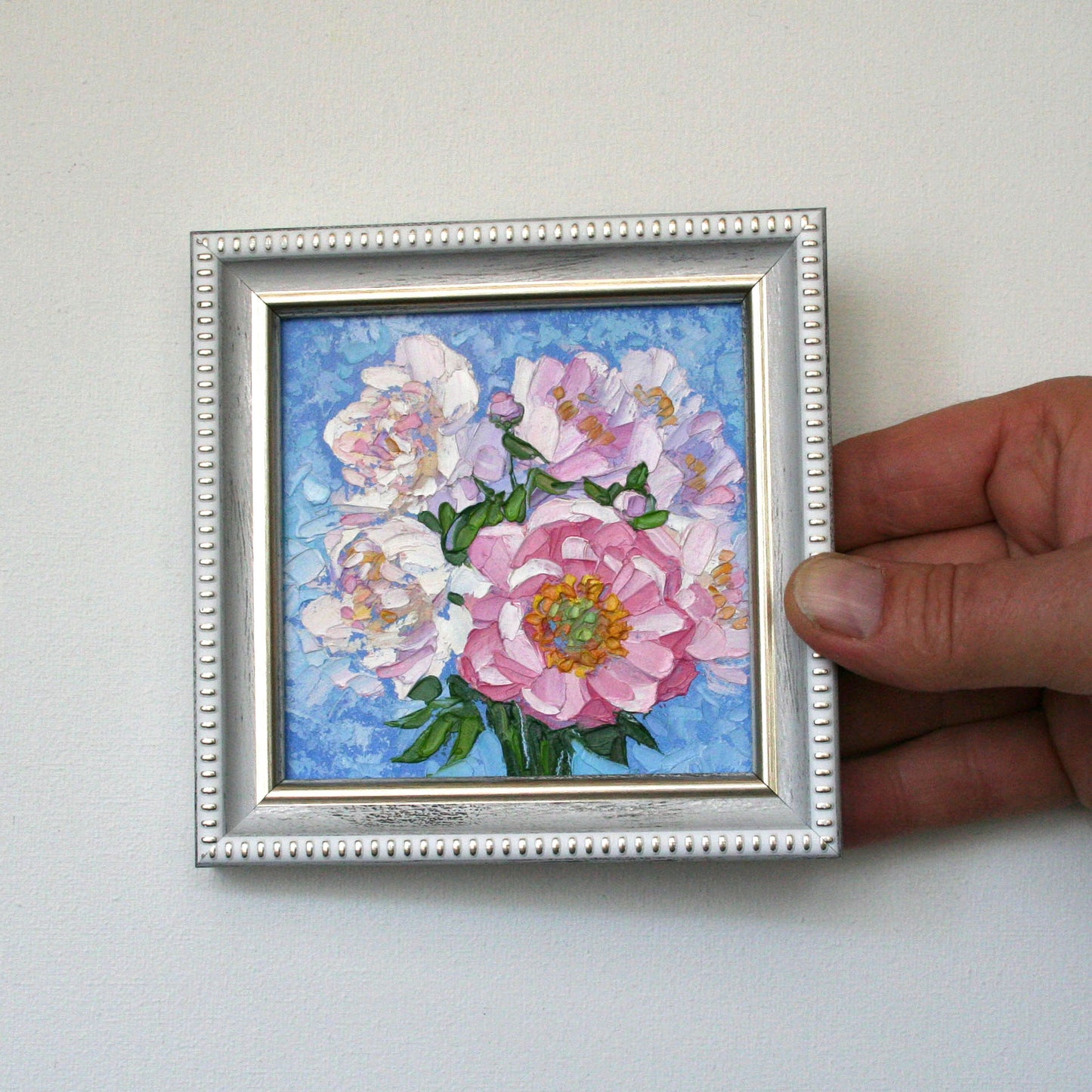Miniature pink peony floral art in a frame.