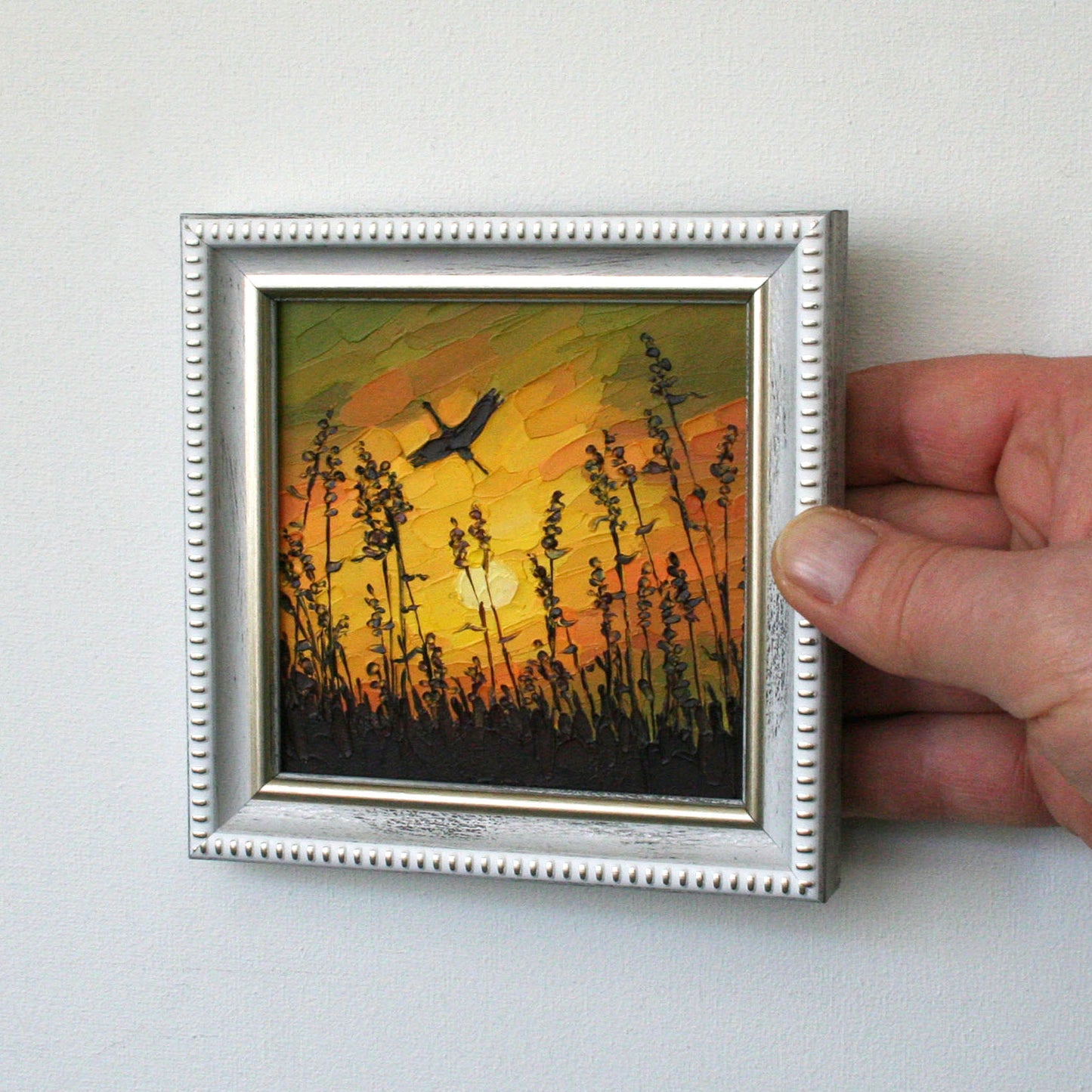Impasto painting of sunset sky and stork with palette knife strokes