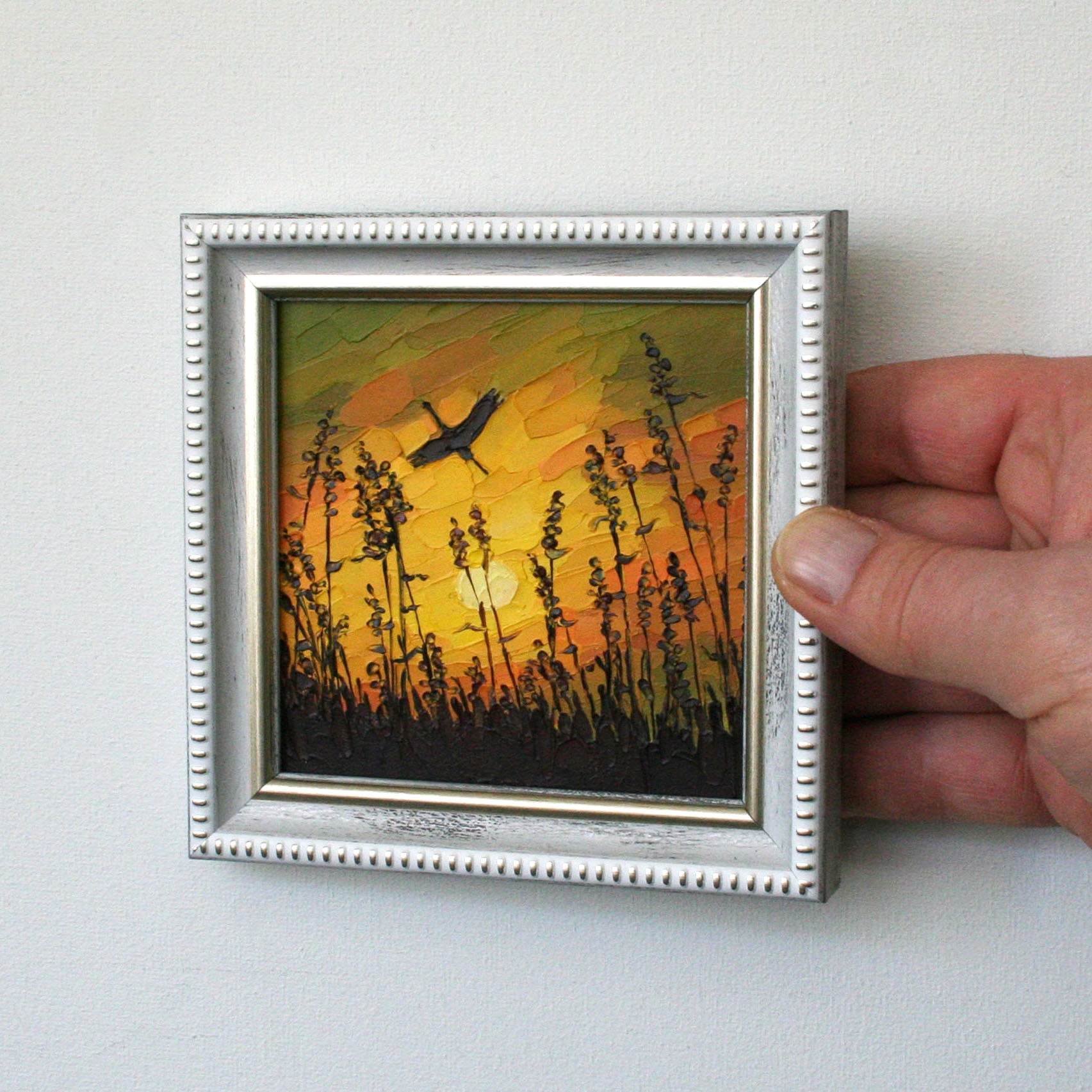 Impasto painting of sunset sky and stork with palette knife strokes