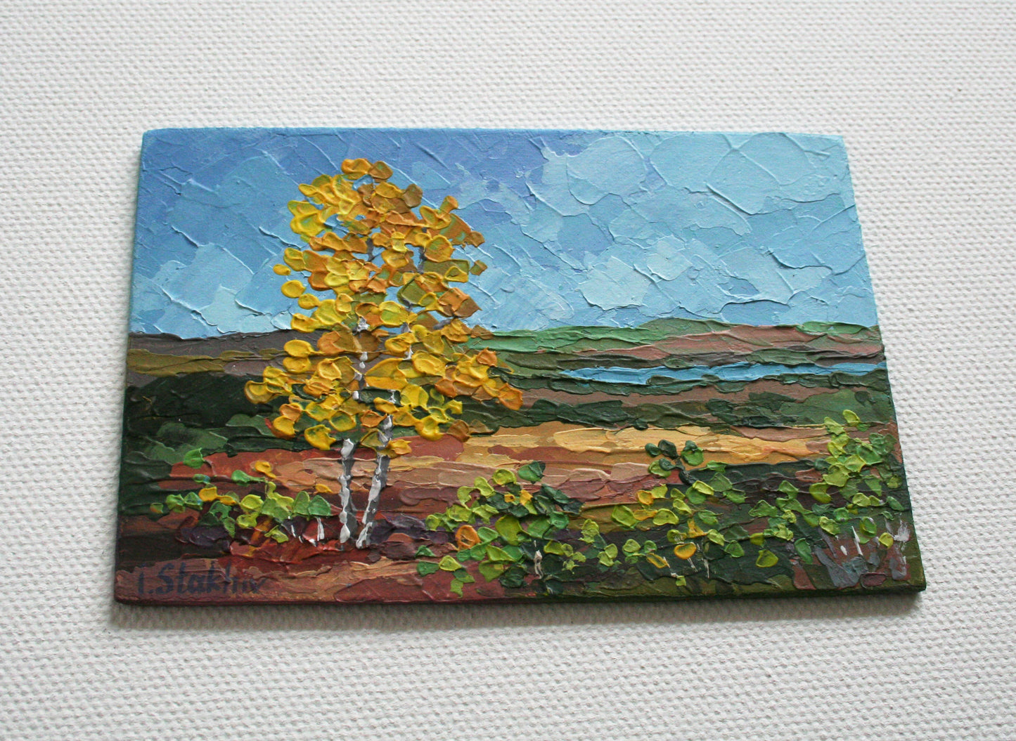 Impasto texture detail of miniature autumn landscape painting on panel