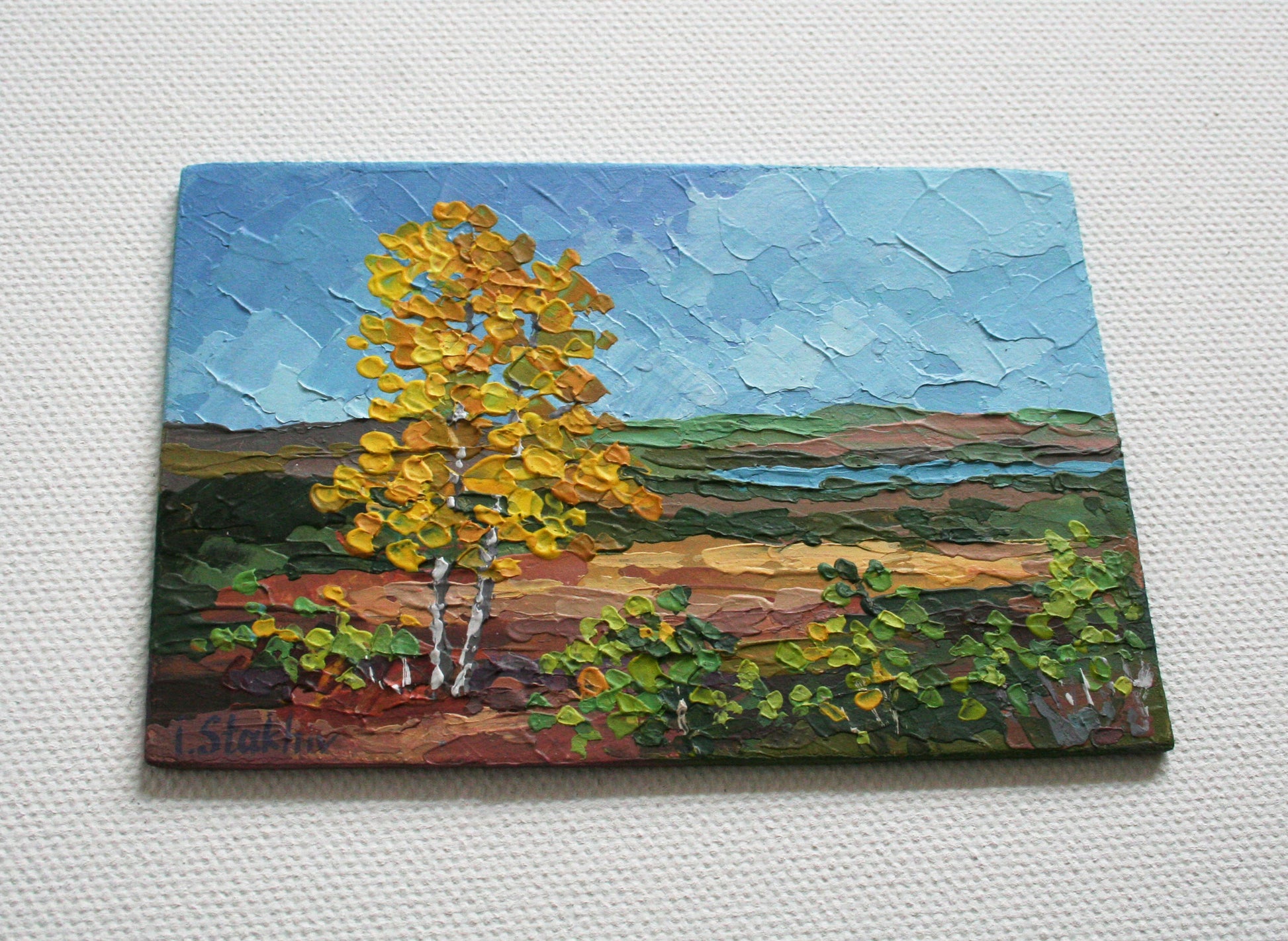 Impasto texture detail of miniature autumn landscape painting on panel
