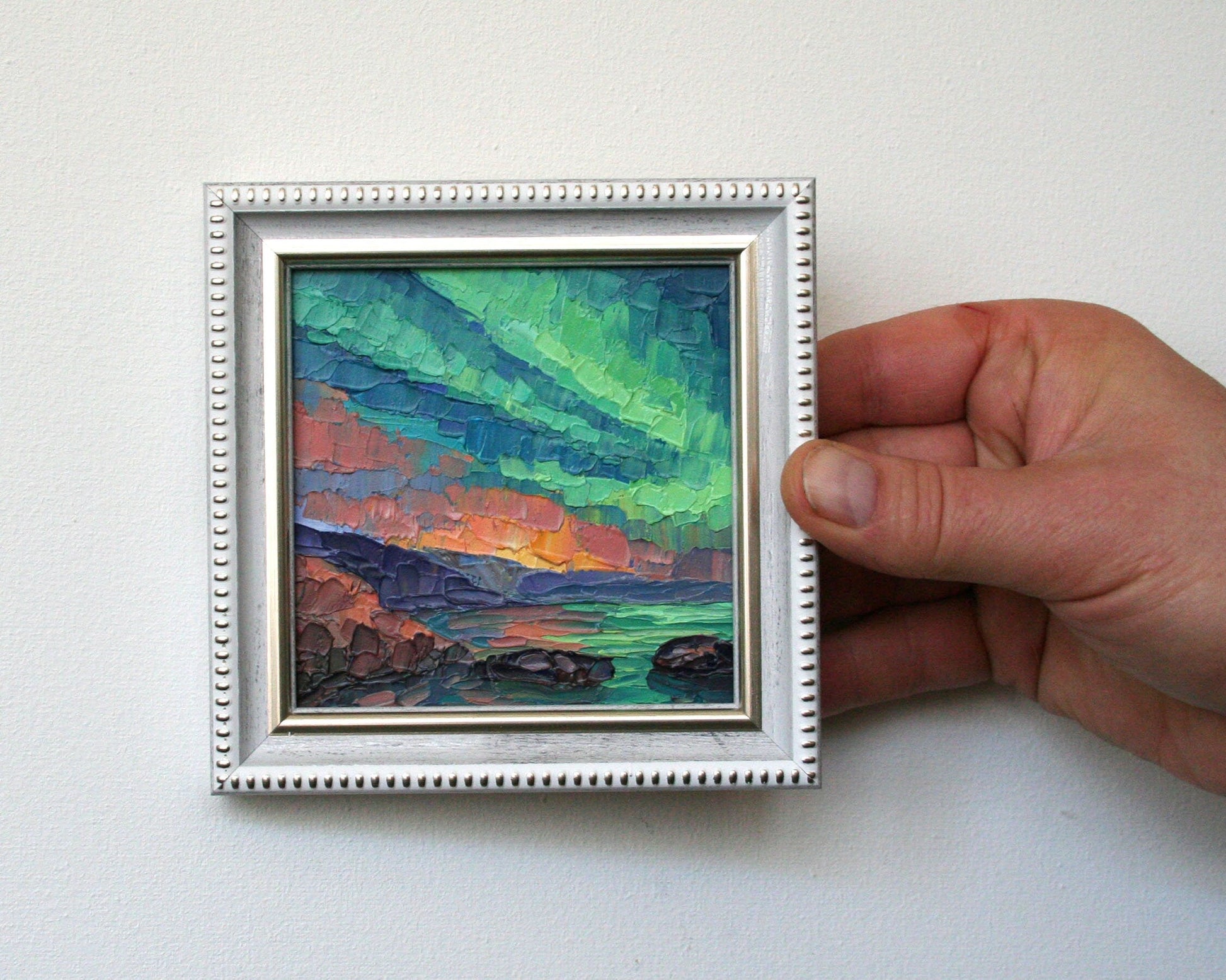 Small framed oil painting of northern lights